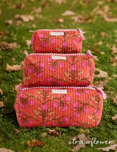 Three quilted blue floral cosmetic bags stacked from largest to smallest against a neutral background.