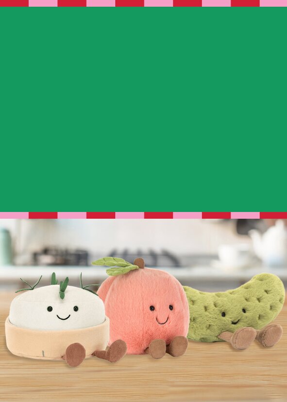 Two models wearing festive sweaters in the snow on a red background