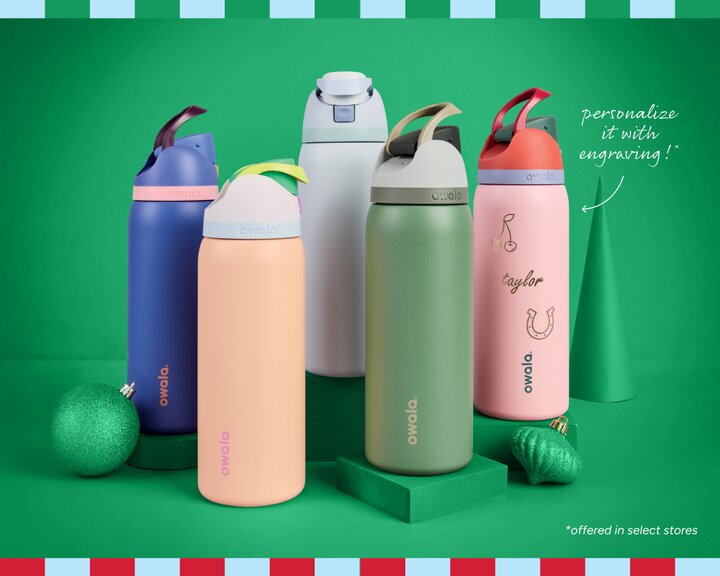 Five different colored Owala water bottles displayed in front of a green background. One engraved with the name "Taylor" and a horseshoe and cherries. Personalize it with engraving - offered in select stores.