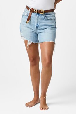 waist-down image of model wearing light wash shorts with distressed hem