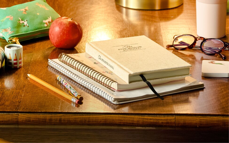 Planner, notebooks, pencils, and study essentials on a desk. Shop agendas and planners.