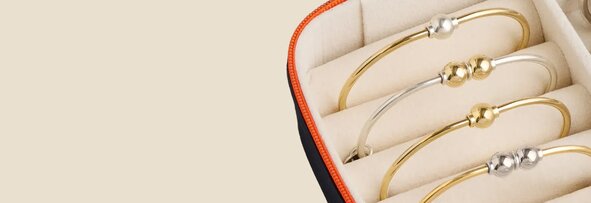 A jewelry box with Cape Cod Bracelets with gold bands and silver balls, and silver bands and gold balls