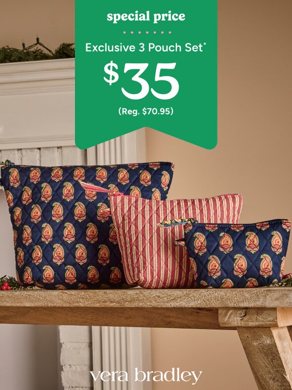 Vera Bradley travel cases sitting under a Christmas tree with red bows on them