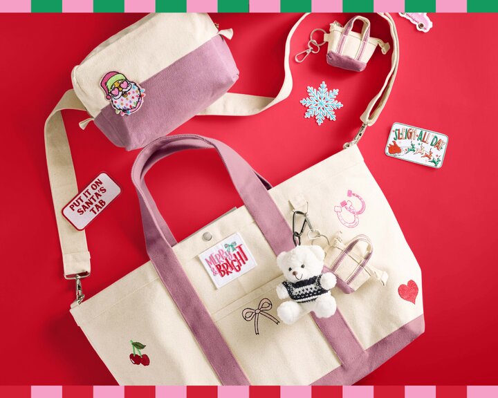 A beige and pink canvas tote bag and cosmetic bag with embroidered patches