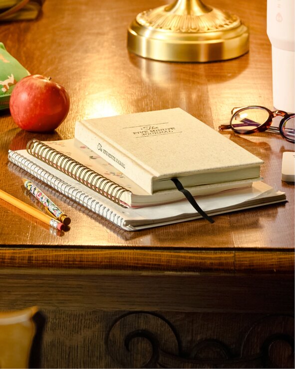 Planner, notebooks, pencils, and study essentials on a desk. Shop agendas and planners.