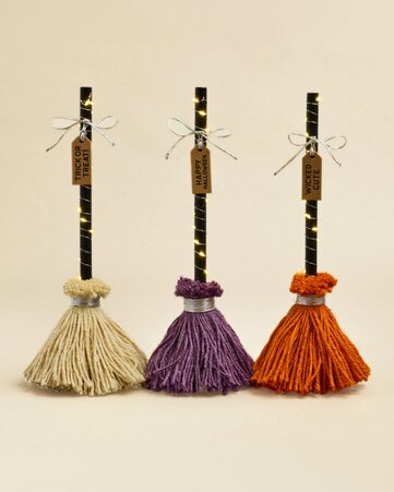 Decorative Halloween LED brooms with festive seasonal designs - 3 for $30