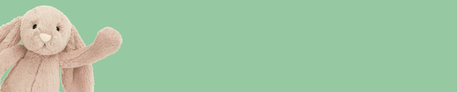 Beige Jellycat bunny waving on a green background