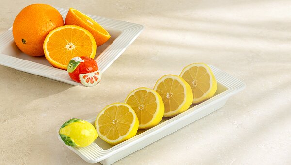 Image of cinnamon buns in a Nora Fleming Pinstripes Border Oval Ceramic Baker Dish with Sweet On You Chocolate Covered Strawberry mini Platter Ornament. Nora Fleming Logo