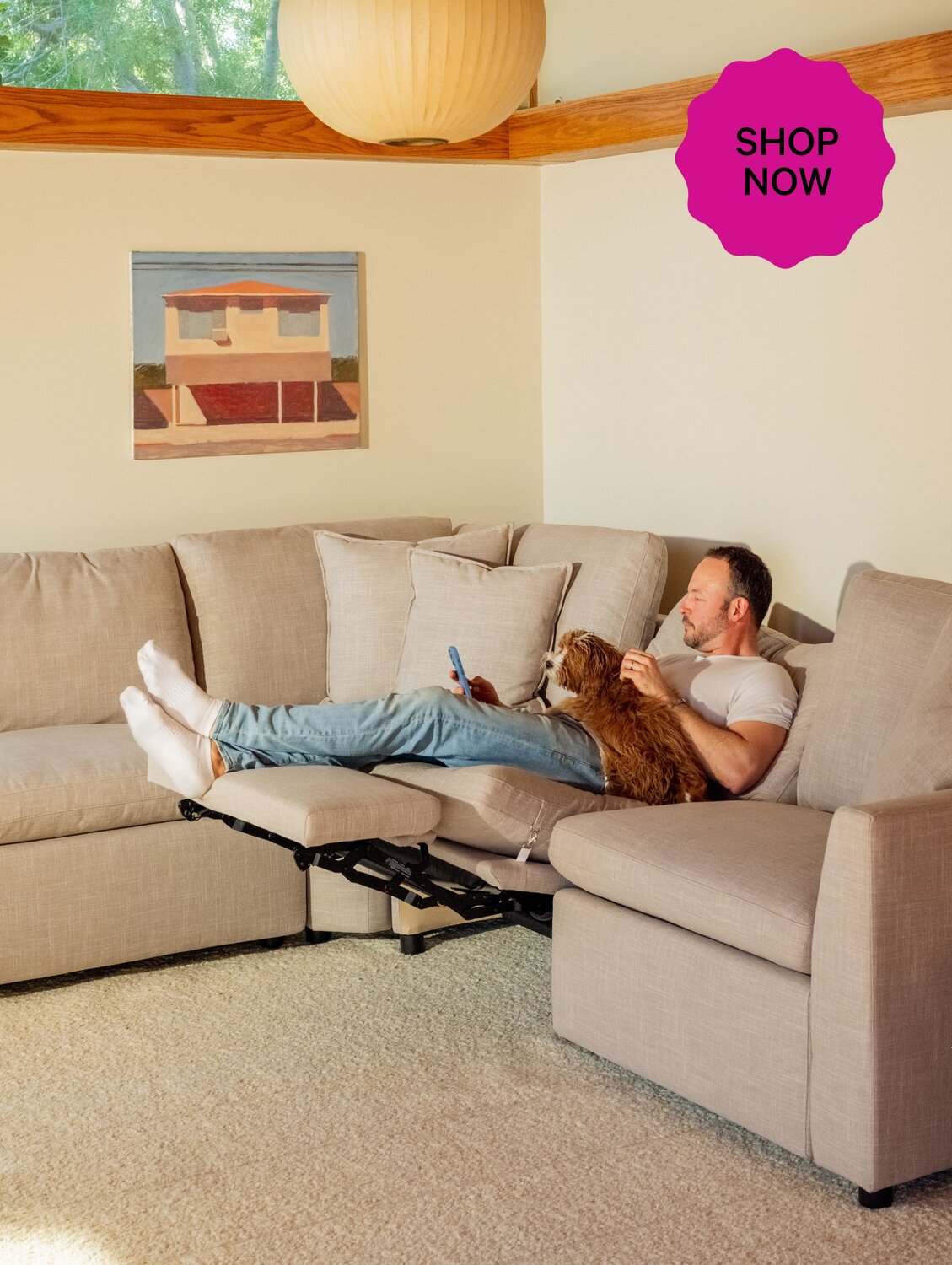 Man reclining in neutral living room.