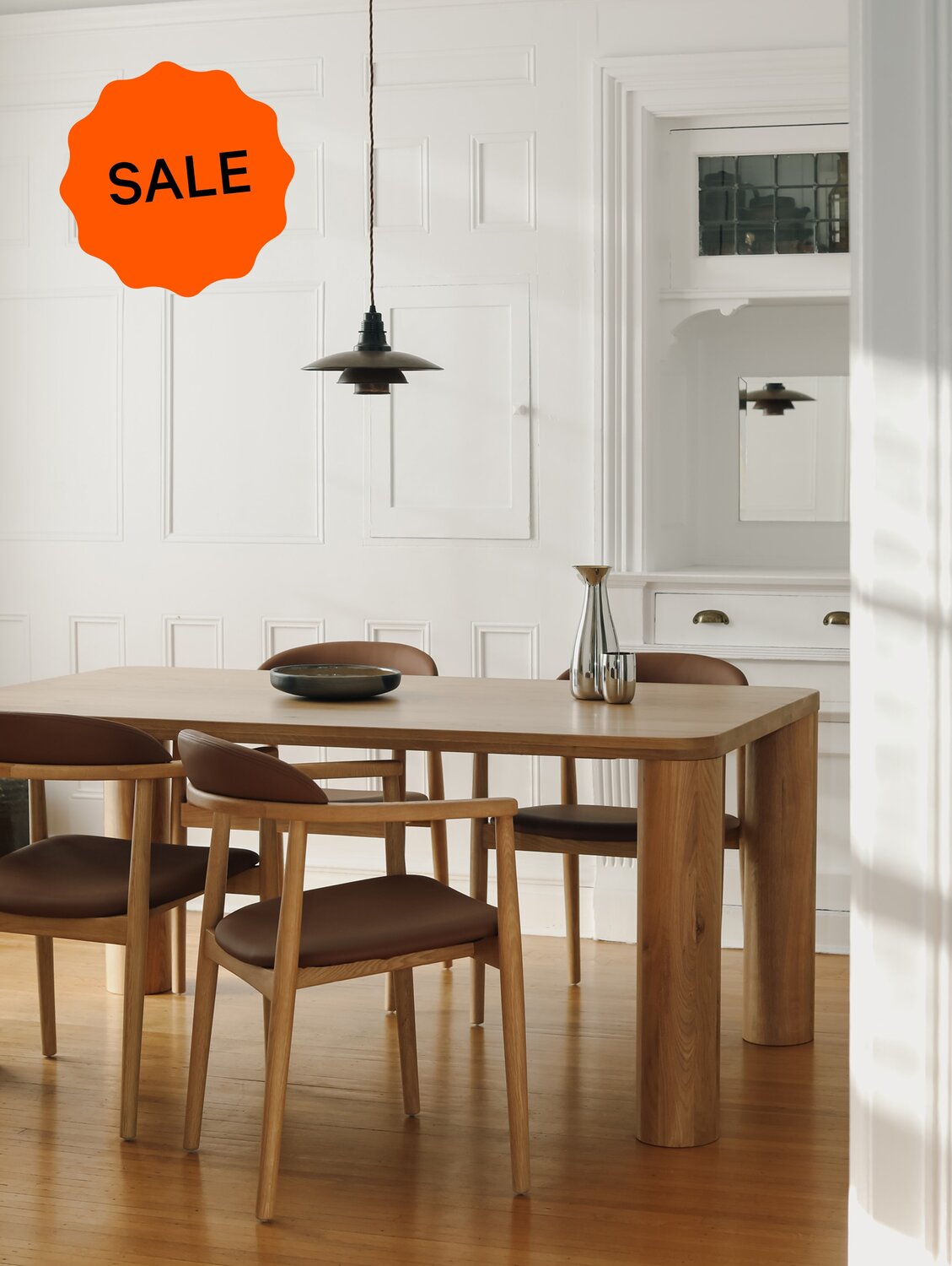 Oak dining table with sale sticker overlay.