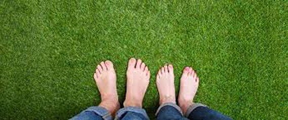 two people standing on grass