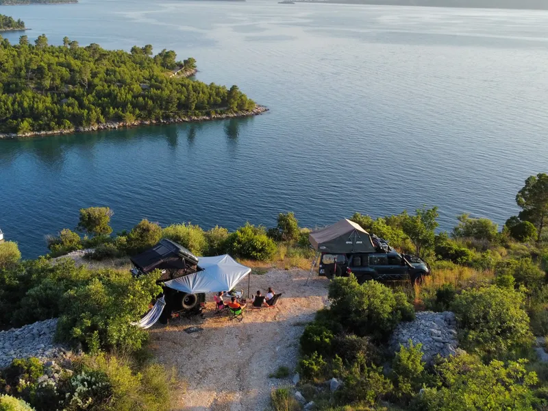 Friends planning a trip with a tablet and notebook