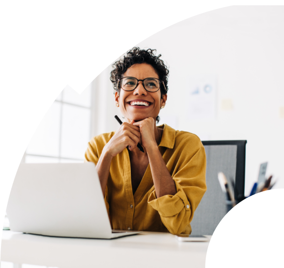 Woman enjoying working on her laptop leaning her head on her hands