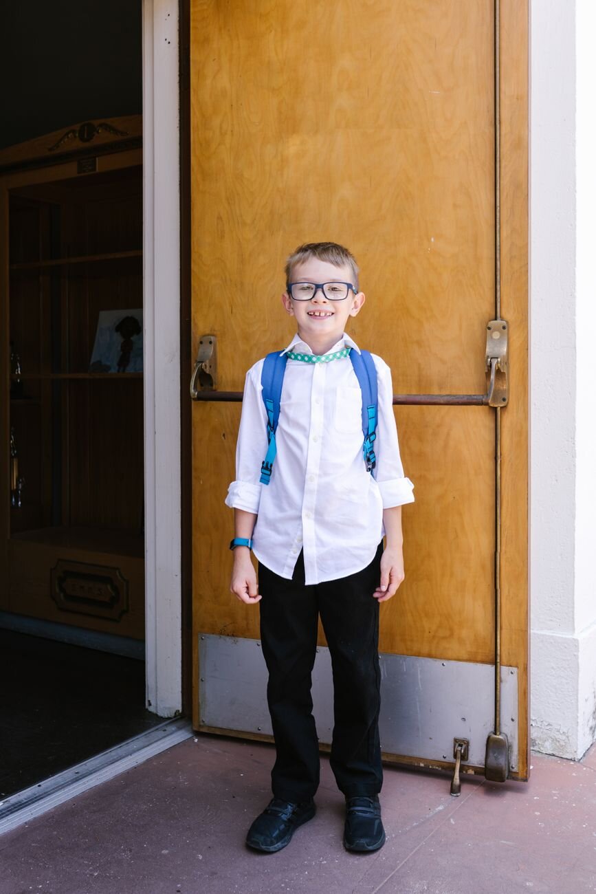 Kid standing in front of door