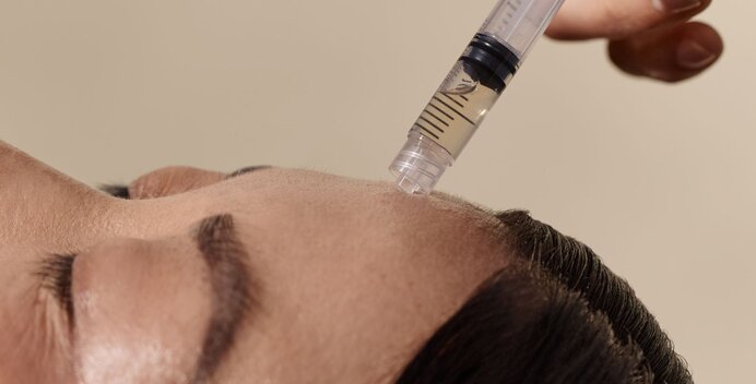 Woman receiving illuminator serum enhancement