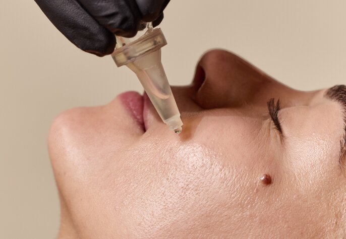 Woman receiving fixer peptide serum enhancement