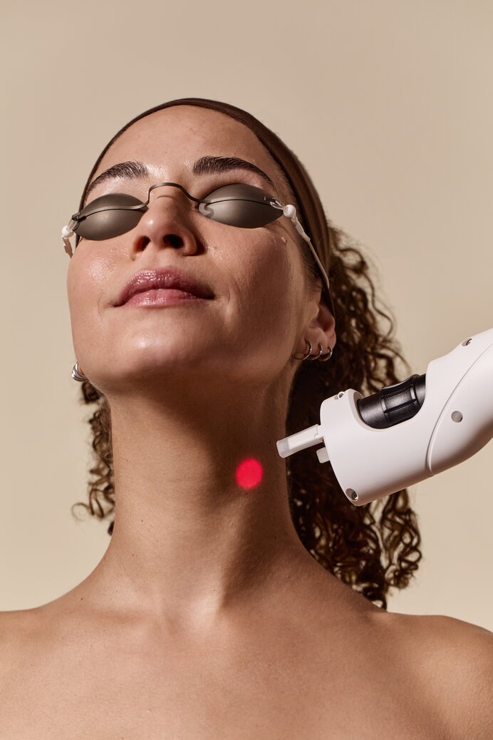 woman receiving a laser treatment on neck