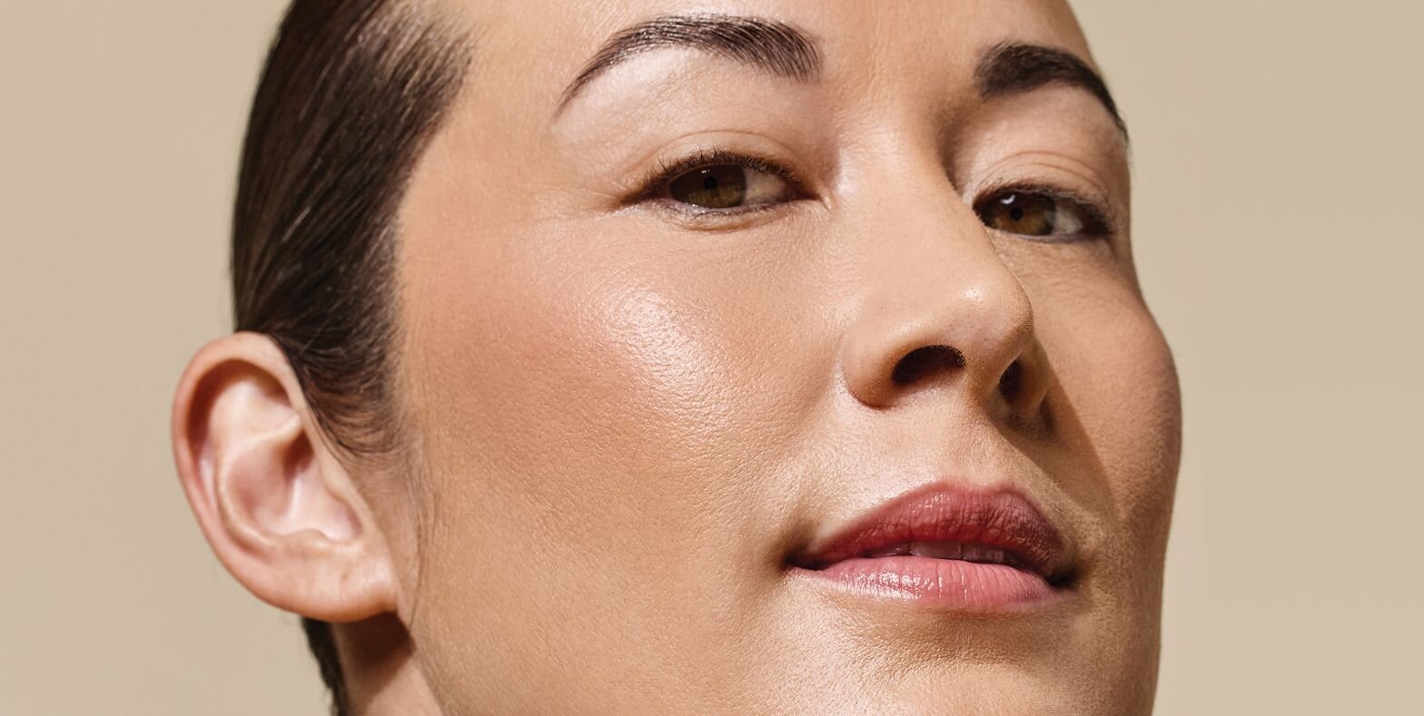 woman's face with glowing, tight skin