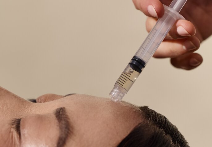 woman receiving a revitalizer facial peel