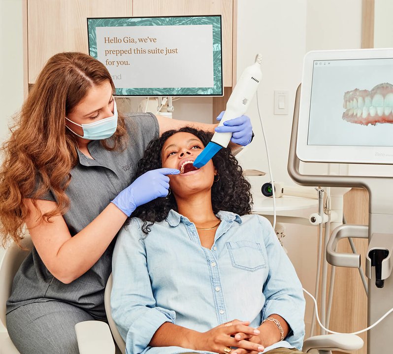 Woman getting teeth scanned