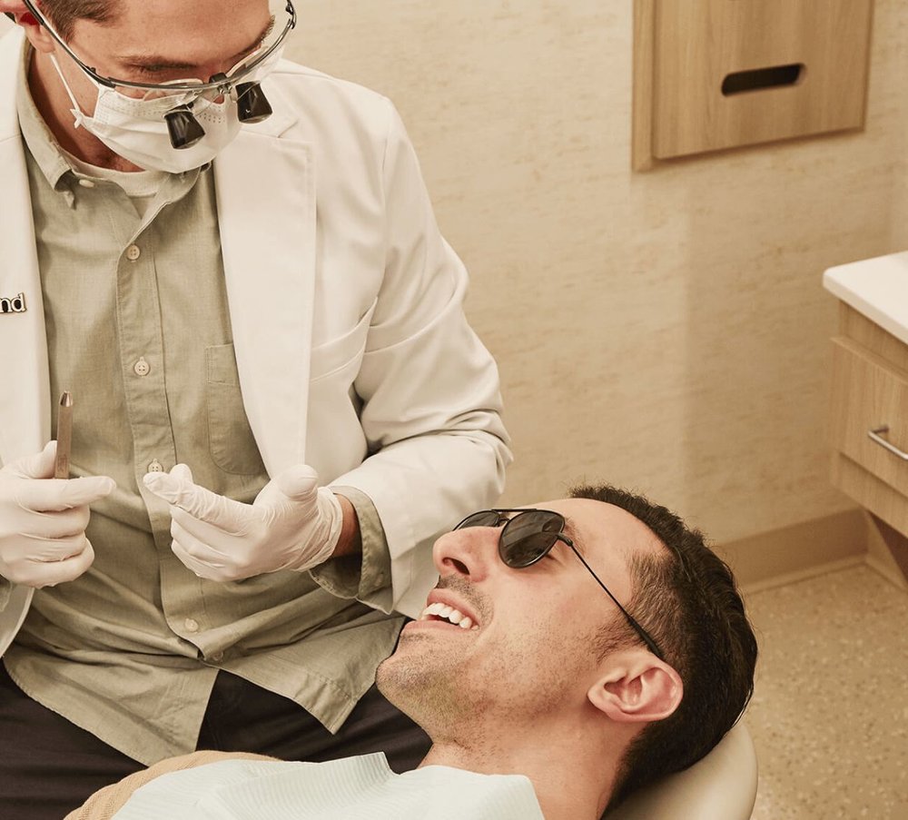 Dentist consulting with dental implant patient