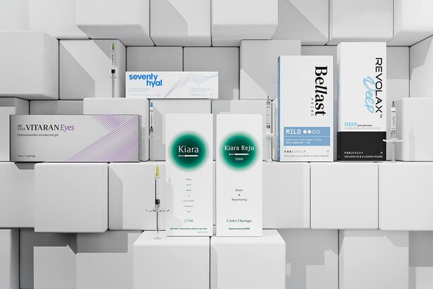 A 3D brick background with Bellast, REVOLAX, Kiara and VITARAN boxes balanced on it