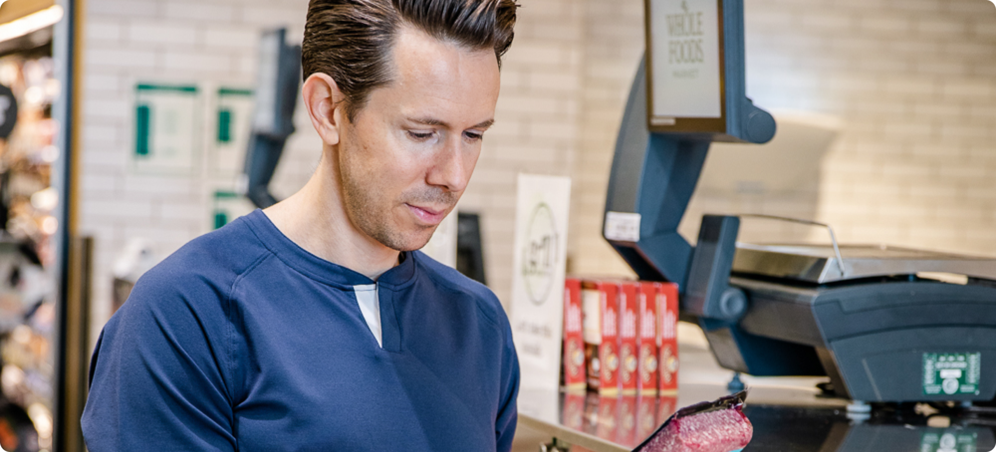 Close up of persons face staring at the ingredients of grocery store bought meat