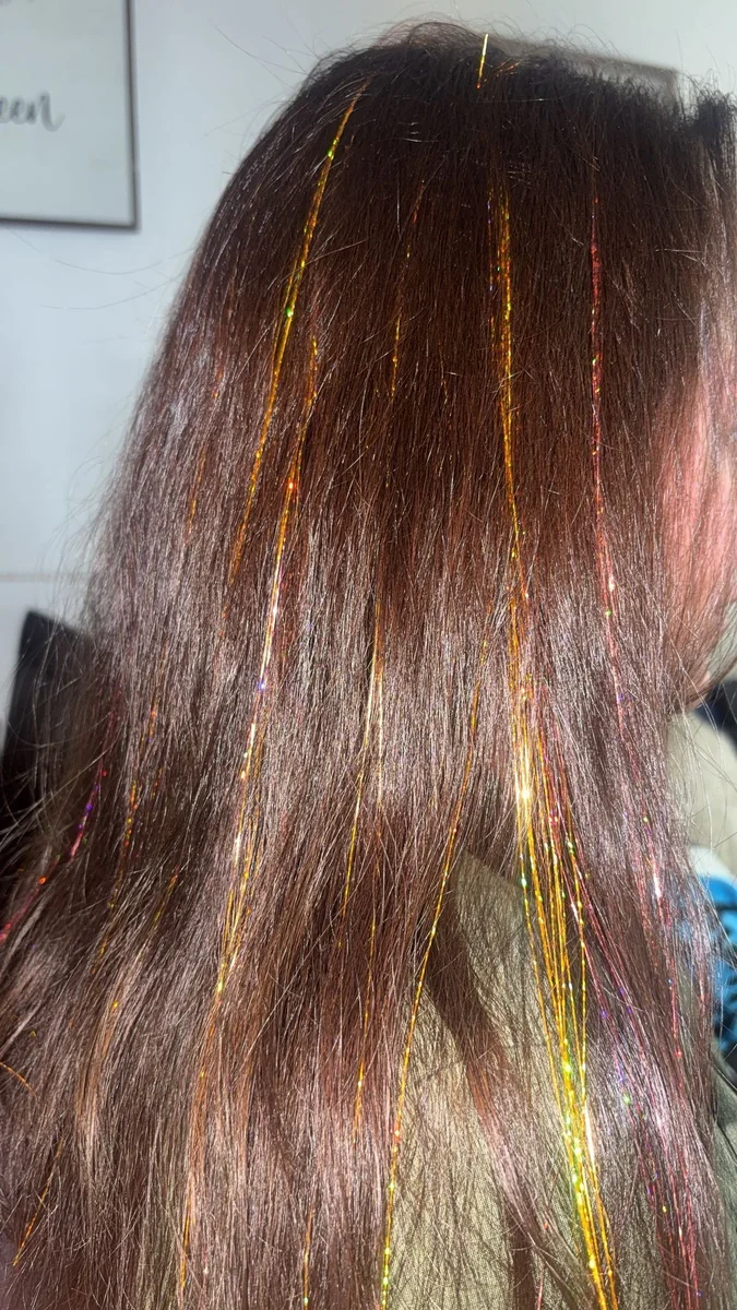 Hair tinsel strands in brown hair
