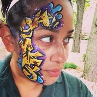 Guest with colorful blue and yellow face paint