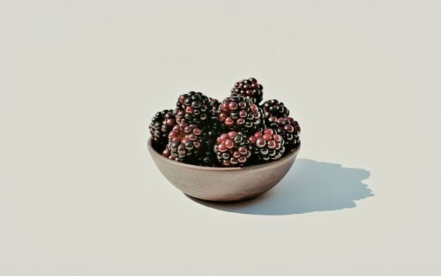 Bowl of fresh blackberries, a naturally sweet, high-fiber low calorie snack that supports healthy digestion and immunity