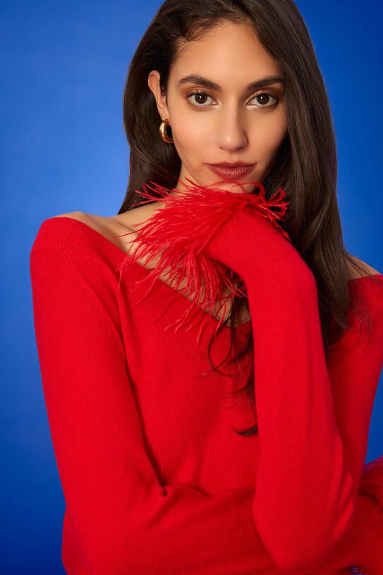 model wearing red feather cuff sweater