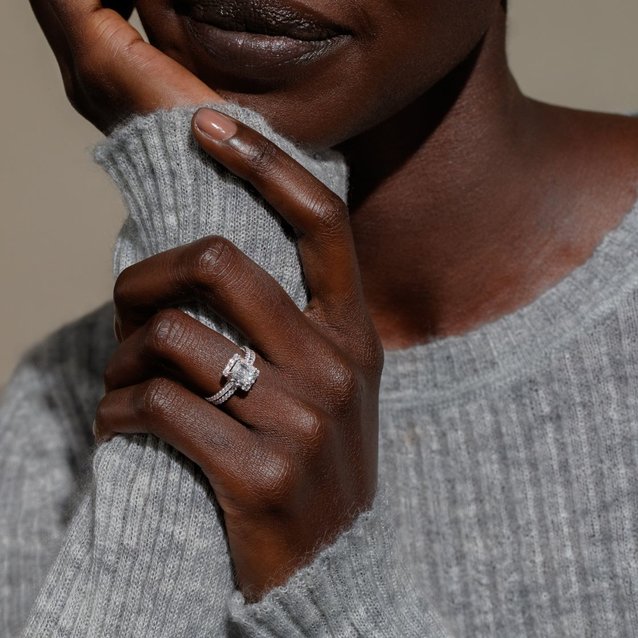 A woman wearing a diamond wedding ring set