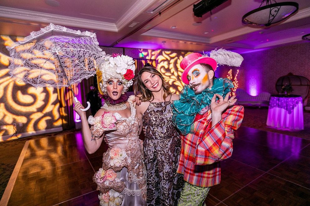 A woman poses with with fancy clowns