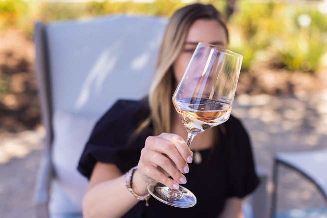 Katherine holds up a glass of rose