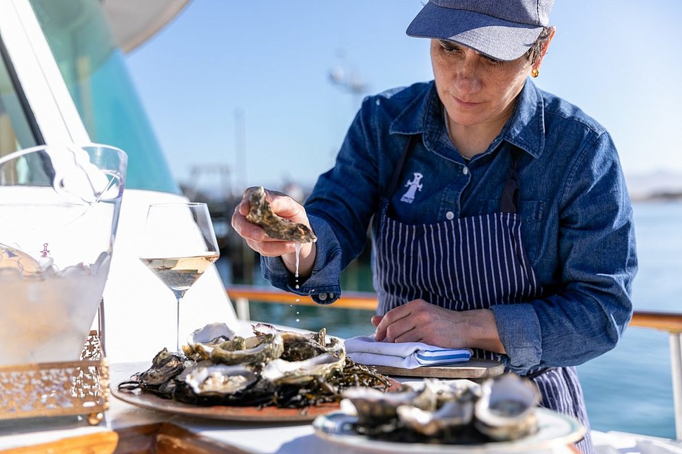 A chef plates oysters