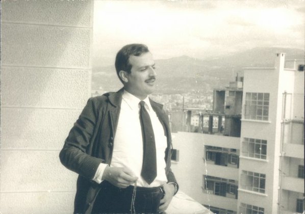 Black and white photo of Joseph Daou standing on a balcony