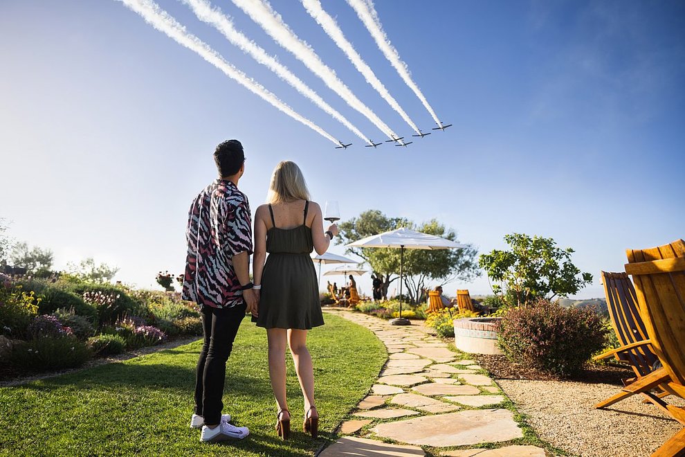 Couple at DAOU Tasting Room watching Tiger Squadron in flight