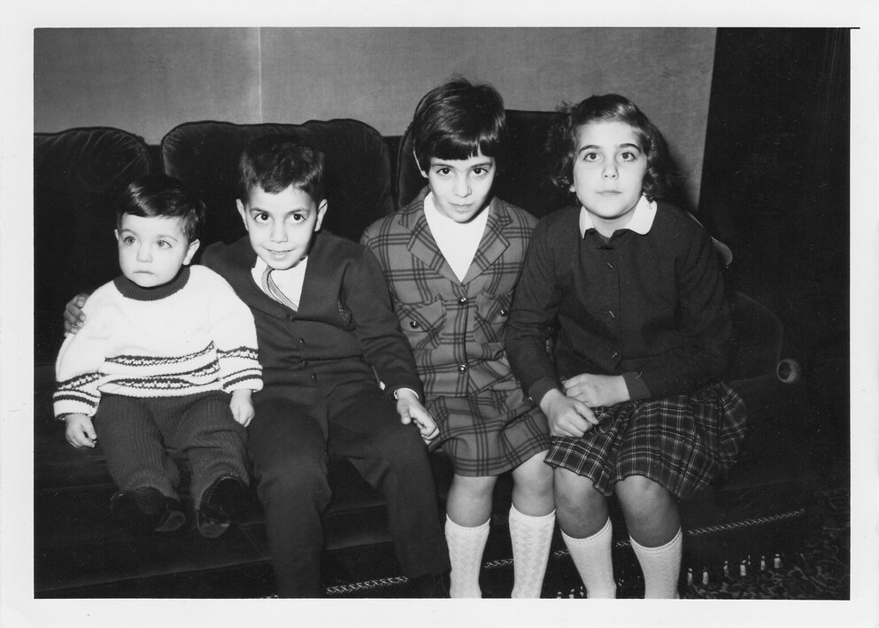 A black and white photo of the four Daou children