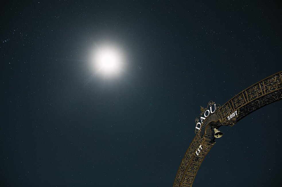 The moon in front of the DAOU Estate arch