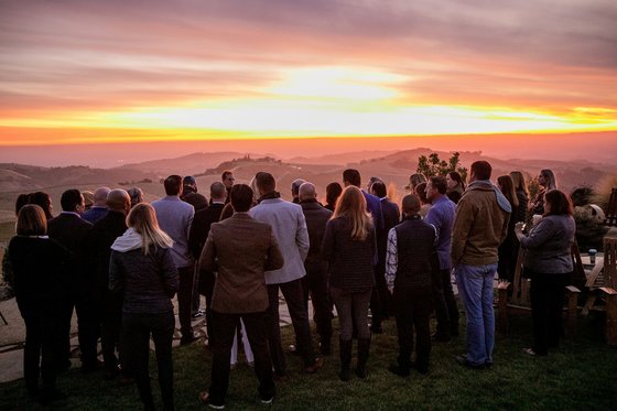 A large group of DAOU employees watch the sunset at DAOU Estate