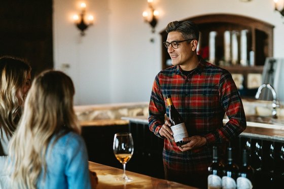 A DAOU tasting room associate greets visitors 