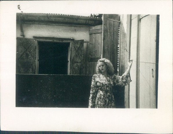 Marie Daou posing in front of a house