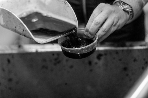Recently pressed juice is poured into a test bowl