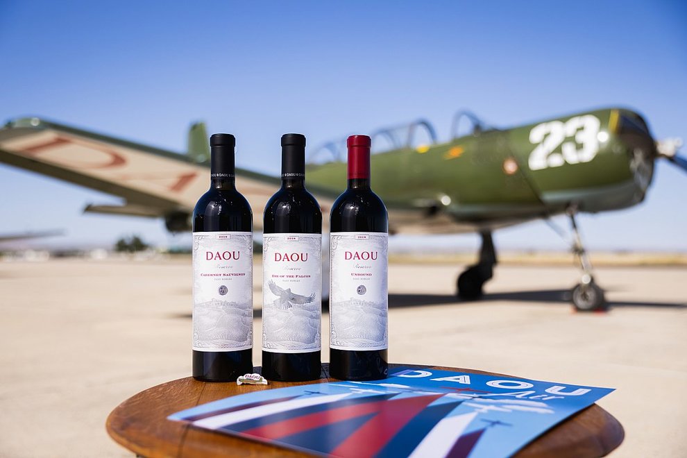 Three bottles of DAOU wine in front of Tiger Squadron plane