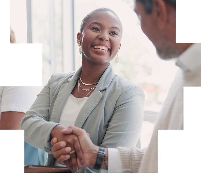 Woman smiling shaking hands with a man