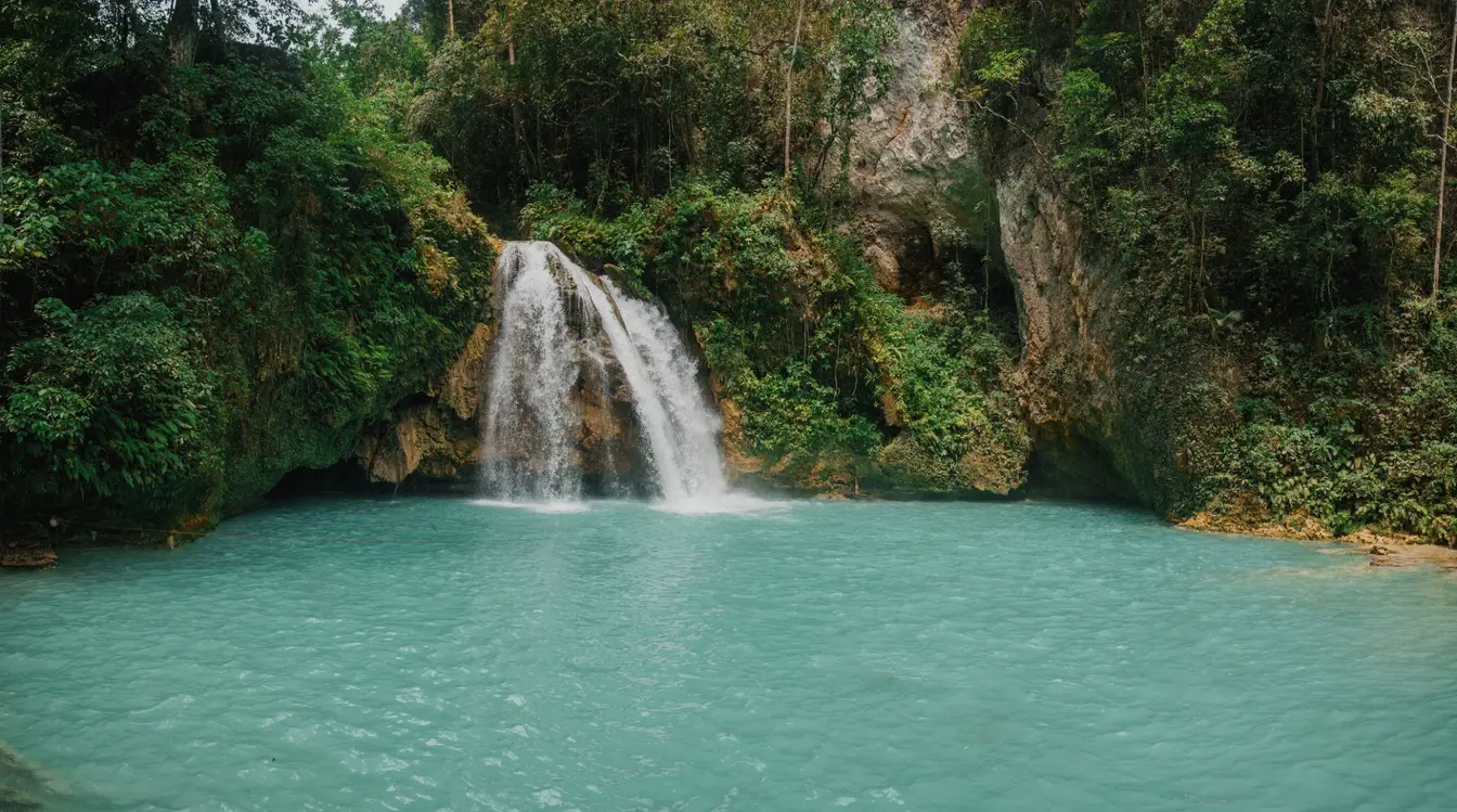 View of Kawasan Falls flowing into a turquoise pool in the jungle of Cebu Island.