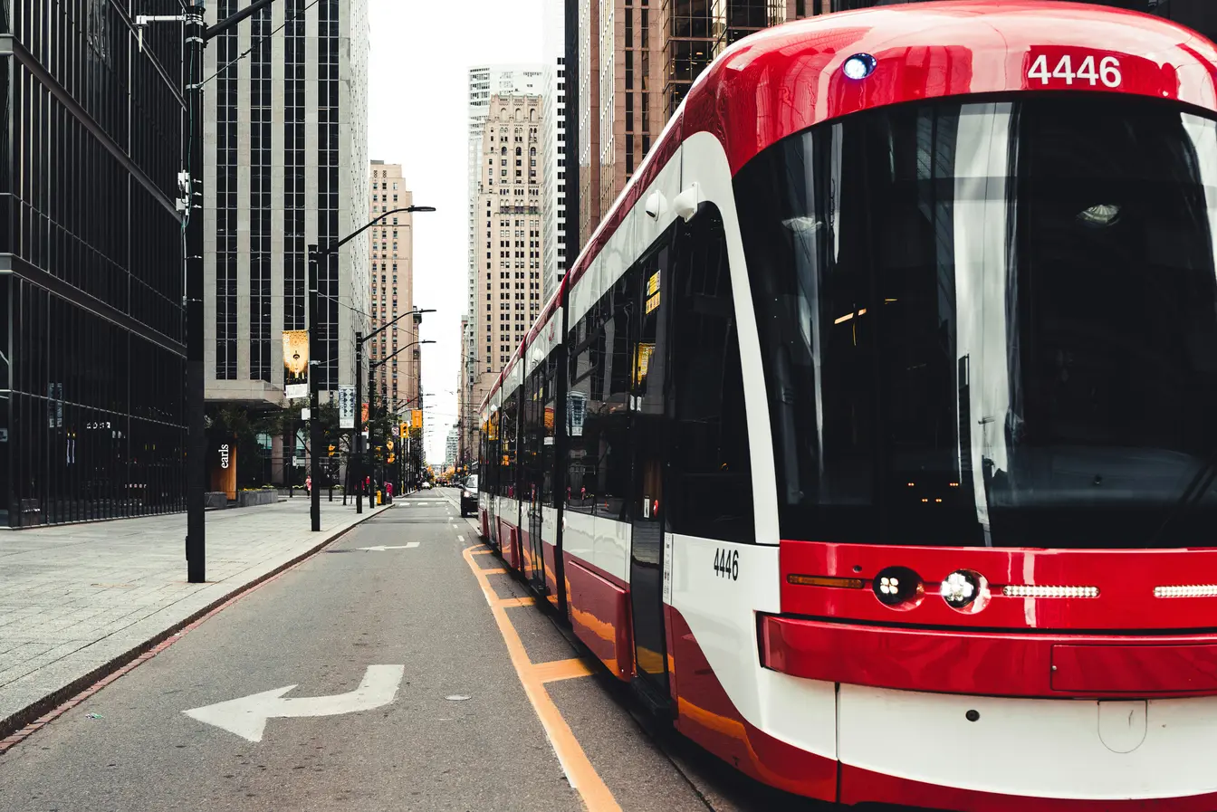  Imagen de un tranvía de color rojo y blanco de la TTC (Toronto Transit Commission) circulando por los carriles reservados en una calle del centro financiero.