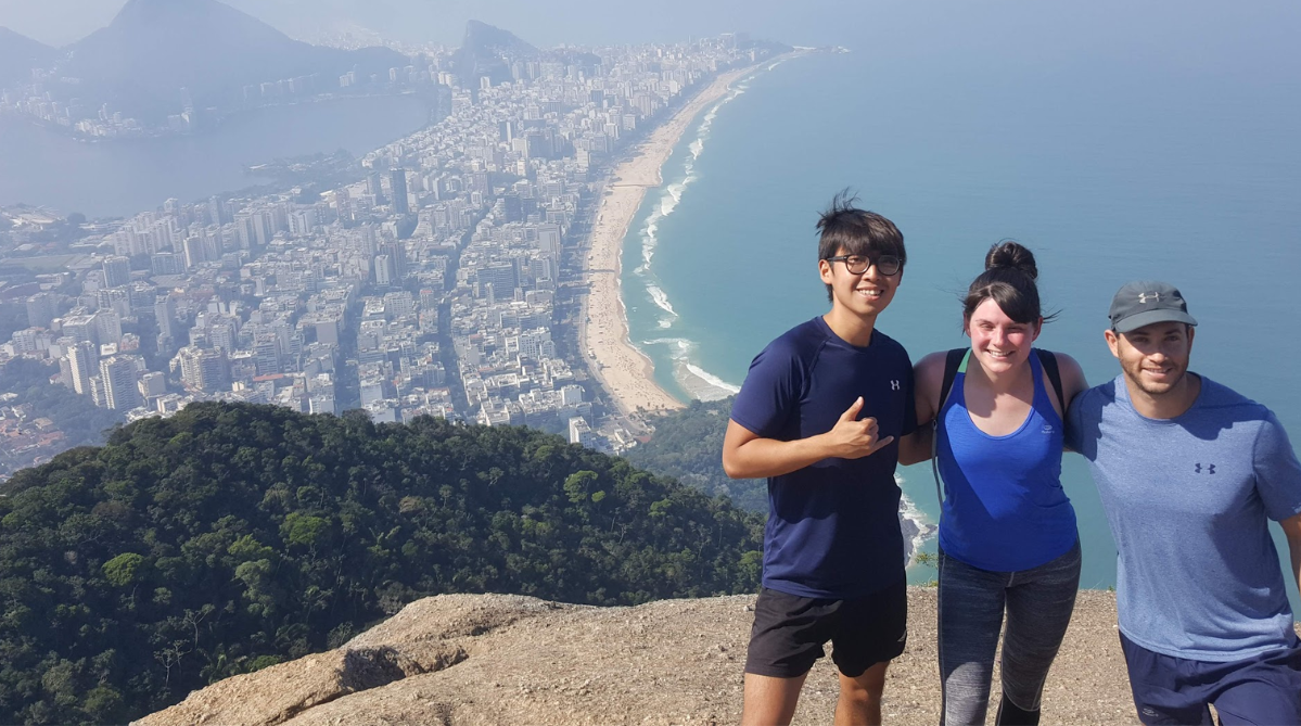 Two men and a woman on top of Morro Dois Irmãos in Rio de Janeiro