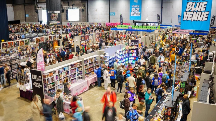 Crowds dressed in colourful outfits and cosplay explore the many shelves of merchandise at Liverpool Comic Con.