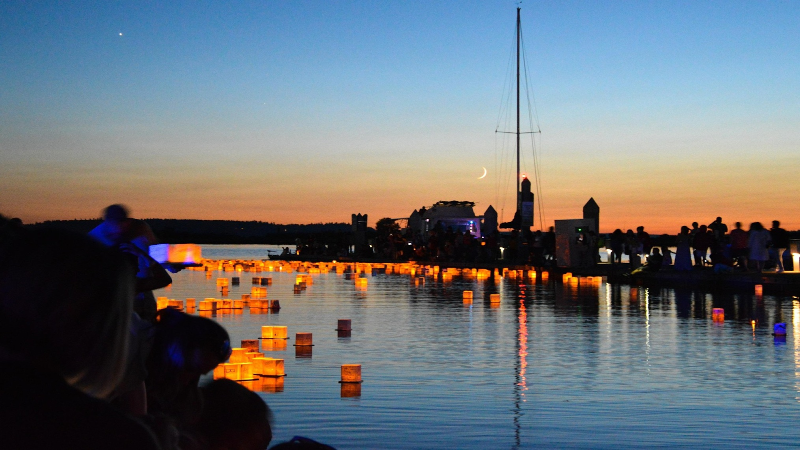 Festival lanterns floating on water in the evening